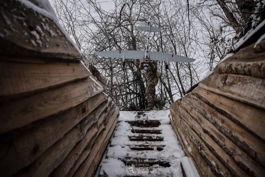 Ukrainian soldier carries the Vector UAV to its launch site